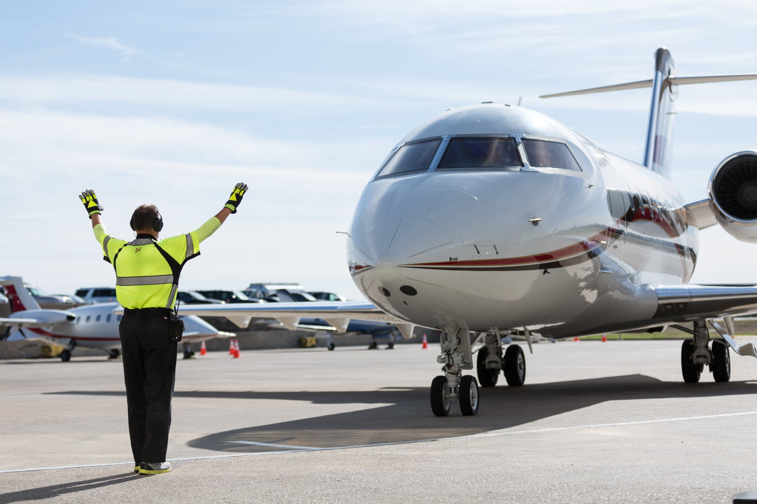 Jet with ground crew providing directions